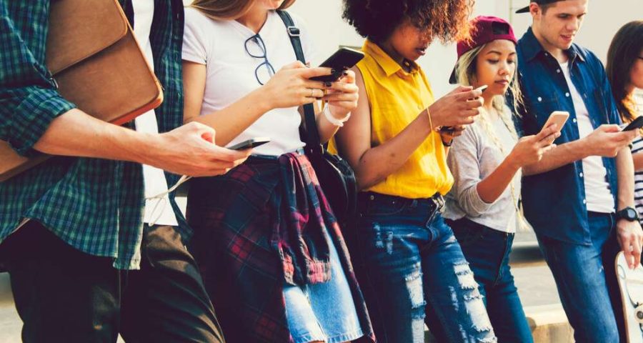 Diverse friends using their phones