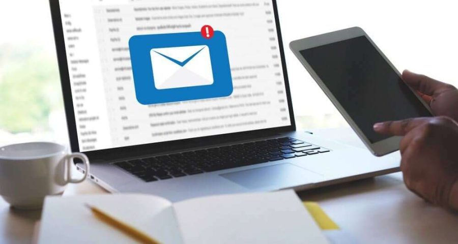 email popup on laptop screen while user opens cell phone