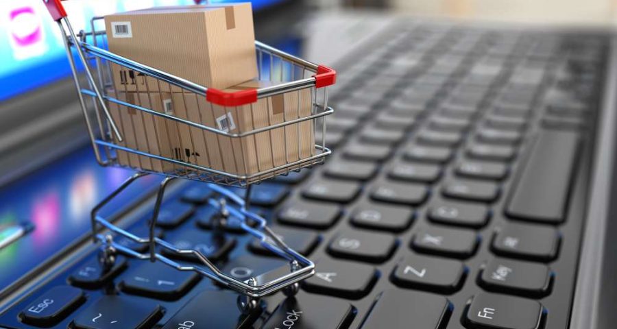 E-commerce.,Shopping,Cart,With,Cardboard,Boxes,On,Laptop.,3d