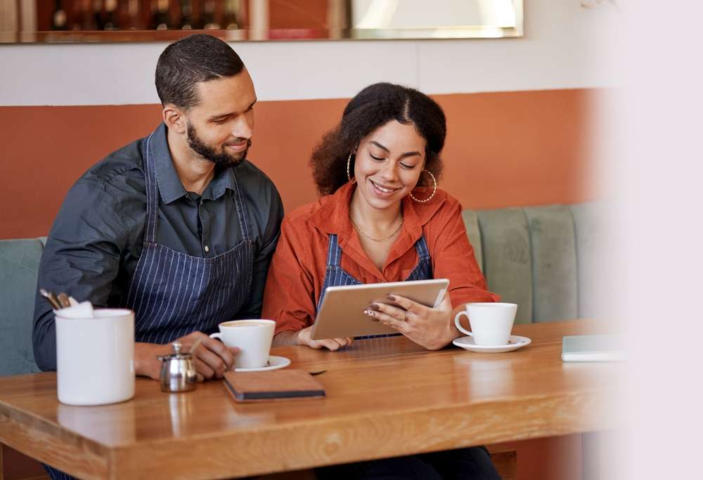 two business owners looking at an Ipad