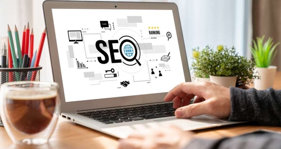 Person on laptop with SEO graphic pictured