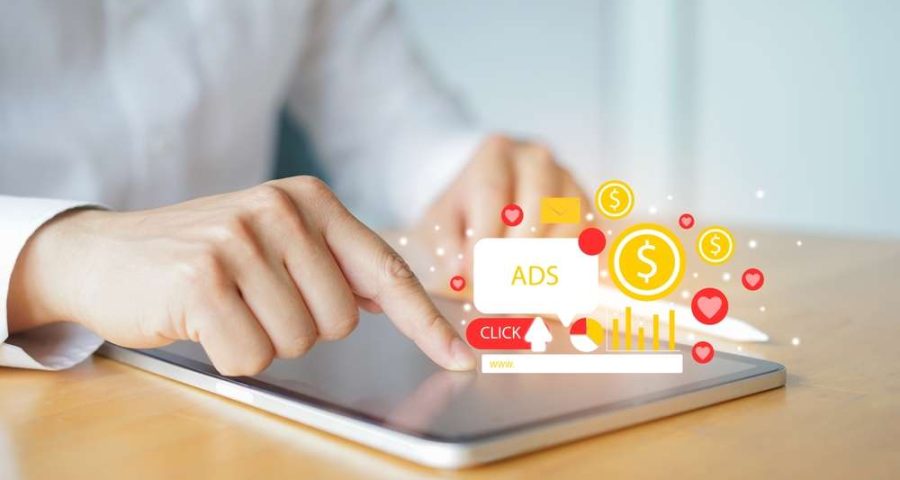 A business person taping a paid advertisement on a tablet