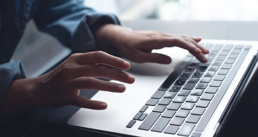 person typing on laptop