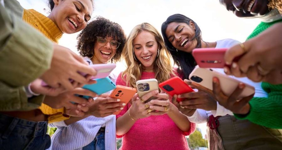 Gen Z on their phones smiling