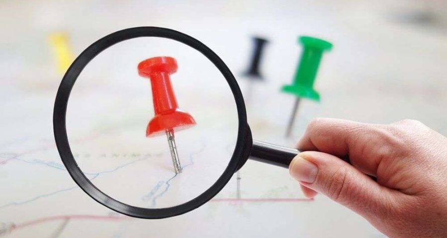 magnifying a push pin on a map symbolizing local search
