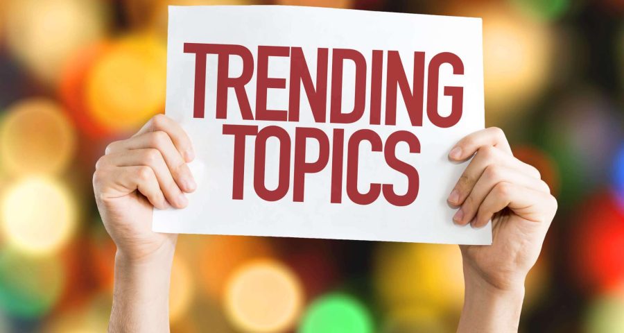 person holding trending topics sign