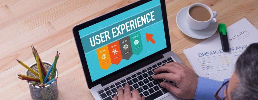 man holding computer with user experience logo