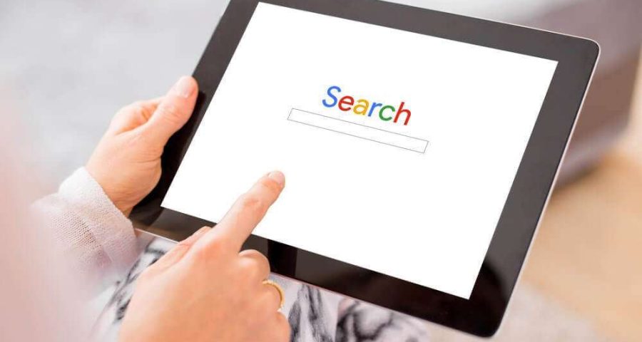 Woman using tablet to search Google